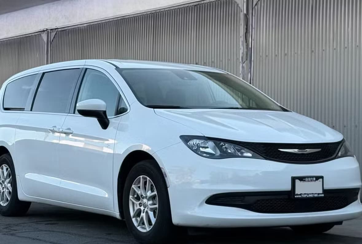 White Chrysler Voyager rental car